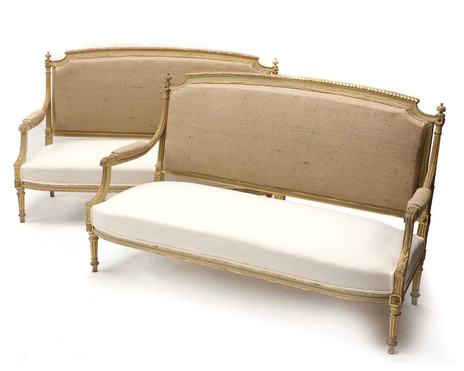 Lot 186 - A pair of French Louis XVI-style painted and parcel-gilt settees