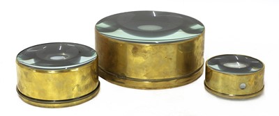 Lot 771 - A set of three graduated brass-bound magic lantern condenser lenses