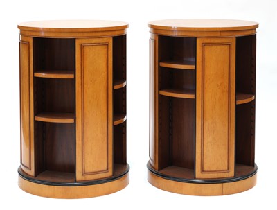 Lot 157 - A pair of maple veneered revolving bookcases