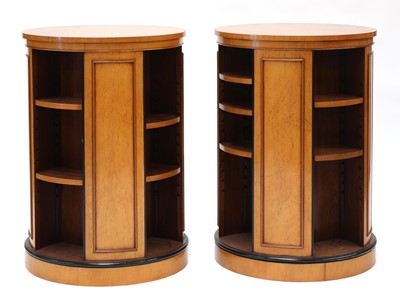 Lot 157 - A pair of maple veneered revolving bookcases