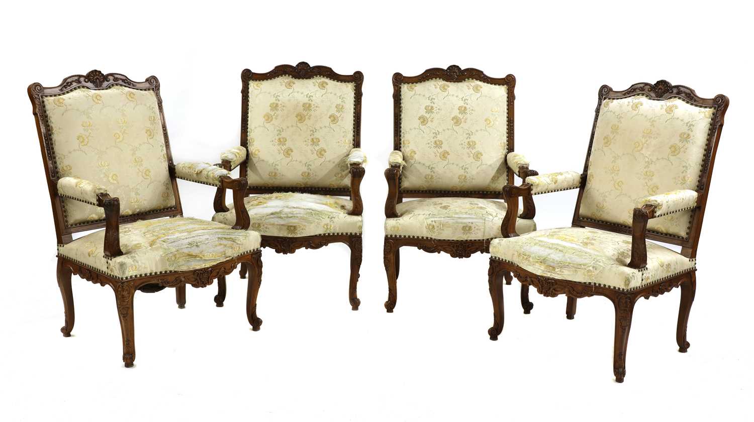 Lot 56 - A set of four French Regency-style walnut elbow chairs