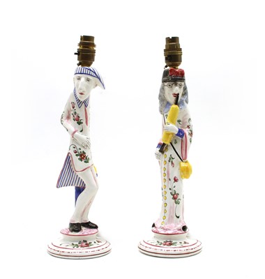 Lot 25 - A pair of French faience caricature figural candlesticks
