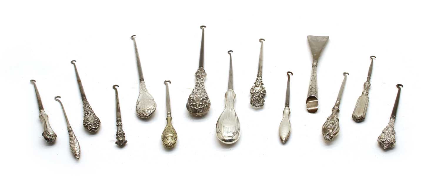 Lot 16 - Twenty six silver handled button hooks and shoe horns