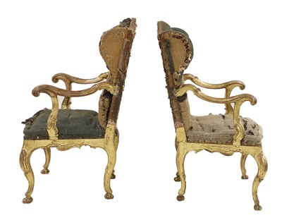 Lot 172 - A pair of Italian carved giltwood wingback open armchairs