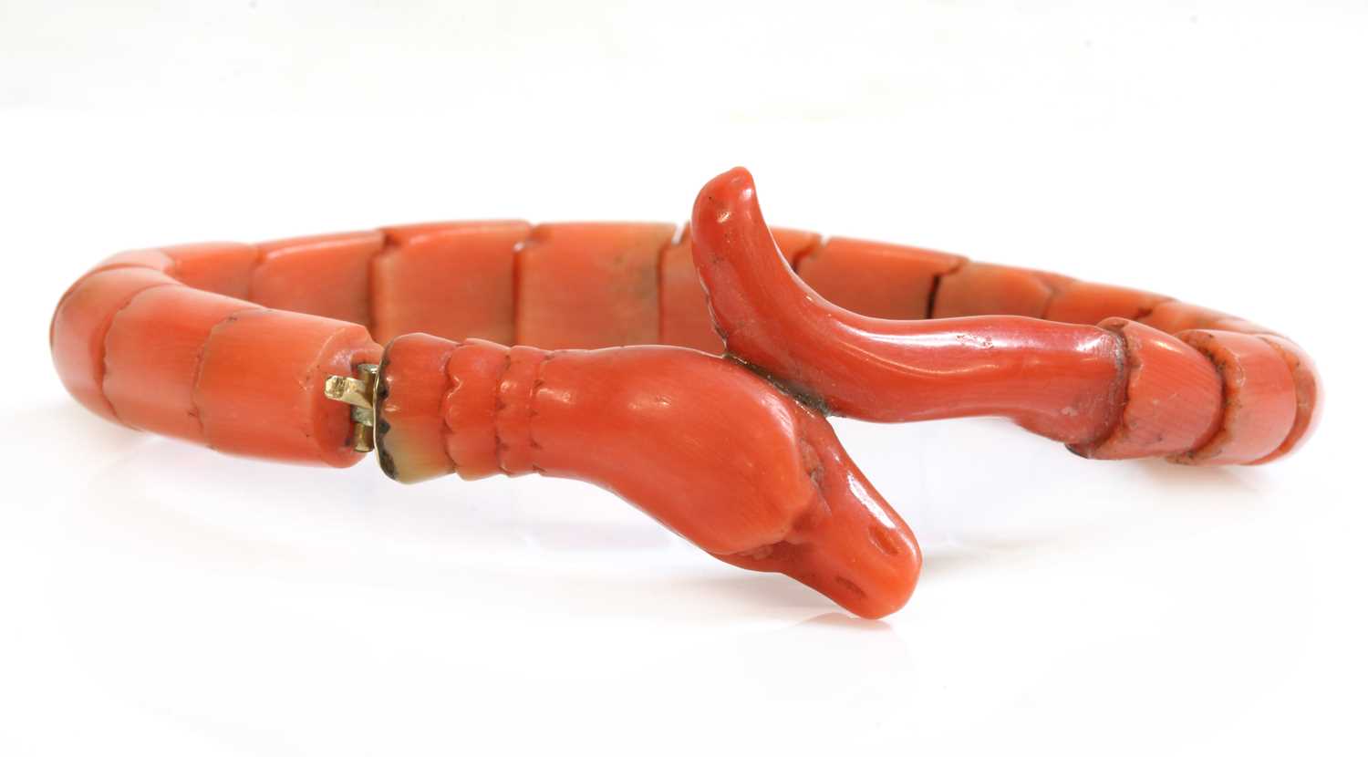 Lot 107 - A late Victorian carved coral graduated snake bracelet, or semi flexible bangle