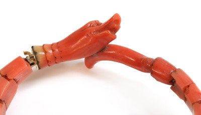 Lot 107 - A late Victorian carved coral graduated snake bracelet, or semi flexible bangle