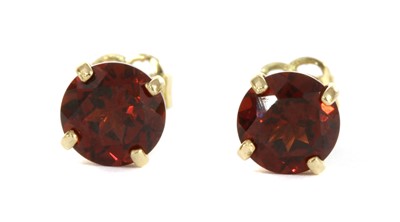 Lot 185 - A pair of gold single stone garnet stud earrings