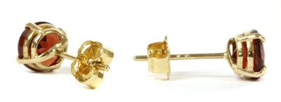 Lot 185 - A pair of gold single stone garnet stud earrings