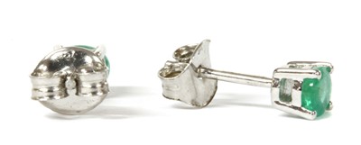 Lot 123 - A pair of white gold single stone emerald stud earrings