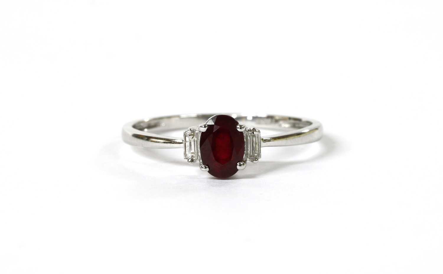 Lot 115 - A white gold three stone ruby and diamond ring