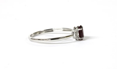 Lot 115 - A white gold three stone ruby and diamond ring