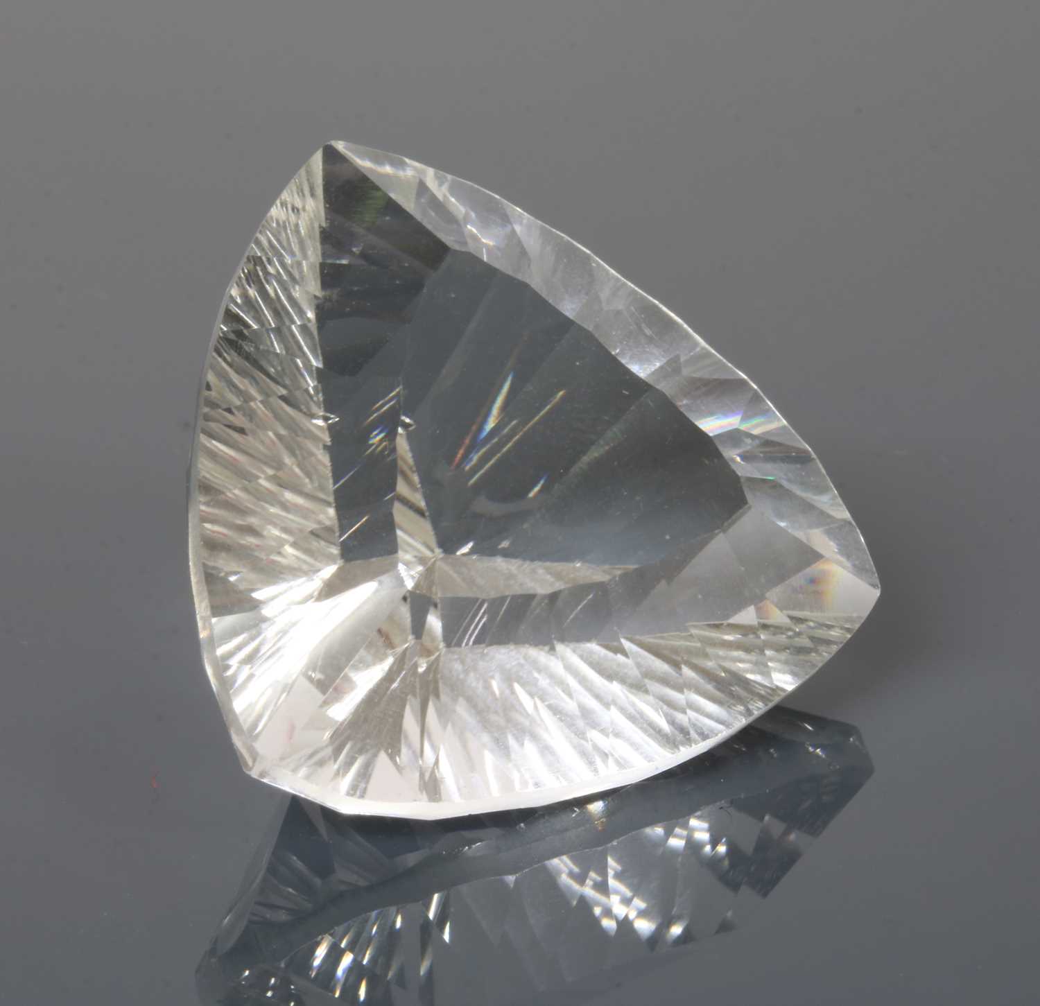Lot 220 - An unmounted triangular laser cut rock crystal quartz