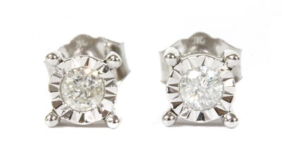 Lot 68 - A pair of white gold single stone diamond stud earrings