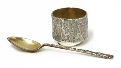 Lot 837 - A silver egg cup and spoon set