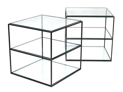 Lot 627 - A pair of Italian three-tier lacquered steel and glass occasional tables