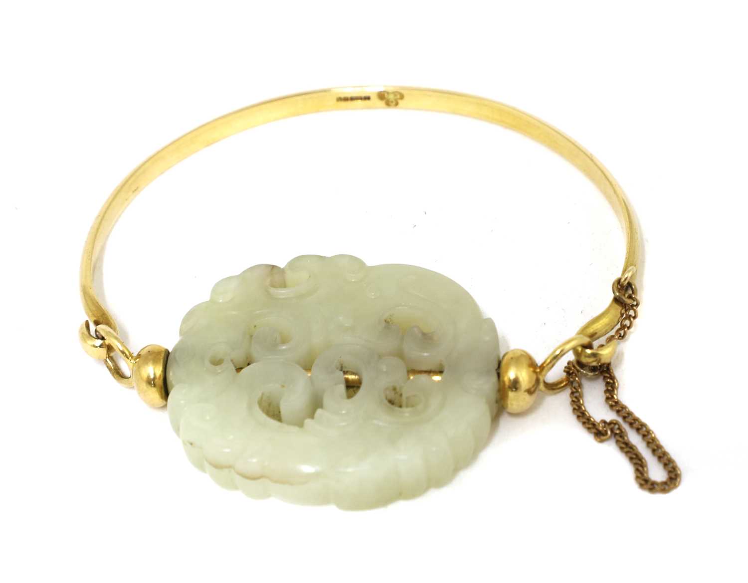 Lot 99 - A Chinese jade and gold bangle