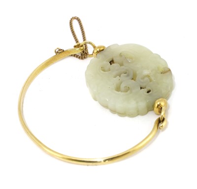 Lot 99 - A Chinese jade and gold bangle