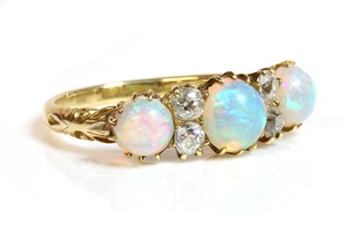 Lot 286 - A Victorian seven stone opal and diamond carved head style ring