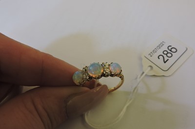 Lot 286 - A Victorian seven stone opal and diamond carved head style ring