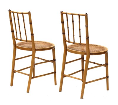 Lot 214 - A pair of Regency-style faux bamboo side chairs