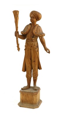 Lot 268 - A carved pine figure of a Venetian boy folding a torch