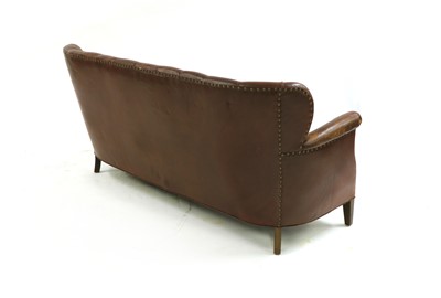Lot 224 - An early 20th century brown leather button back settee