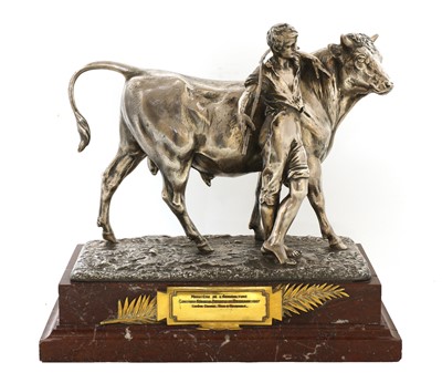 Lot 542 - A silvered bronze agricultural trophy in the form of a bull and handler