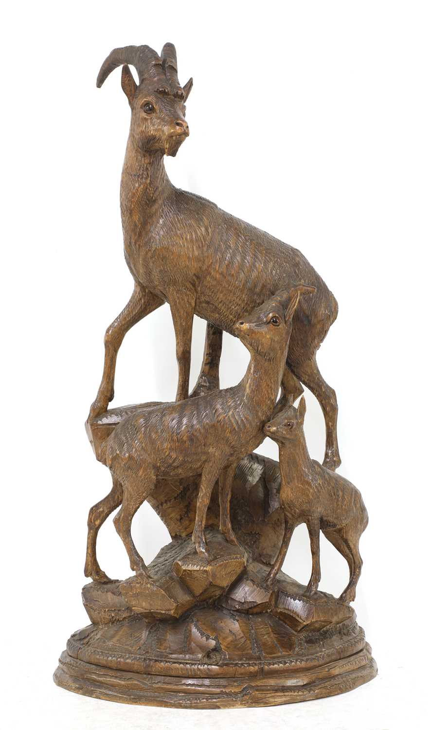 Lot 520 - A Black Forest carved linden wood figure group of mountain goats