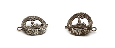 Lot 214 - A pair of silver South Wales Borderers cap badges