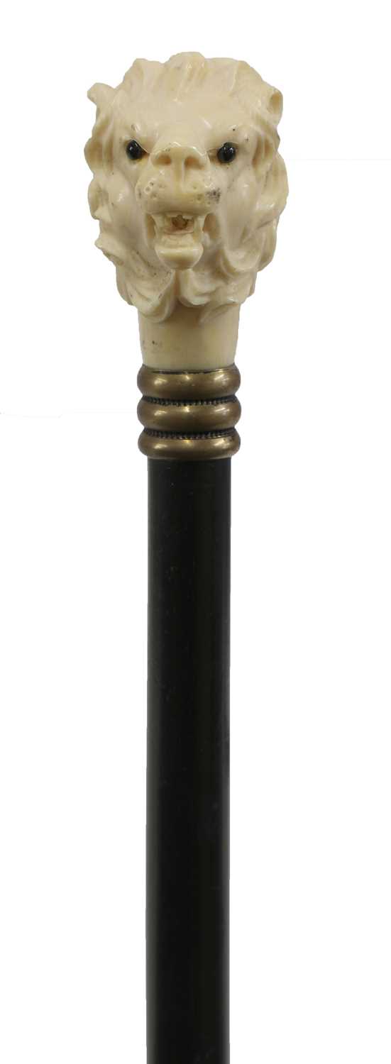 Lot 79 - A carved ivory and ebonised walking stick