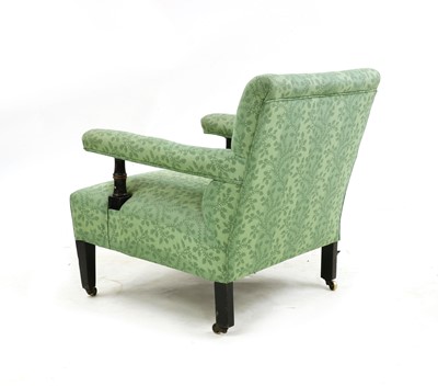 Lot 320 - A Howard style ebonised armchair
