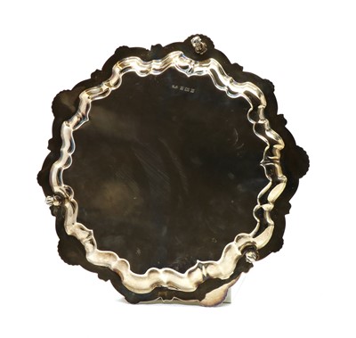 Lot 42 - A silver salver with C scroll shell border