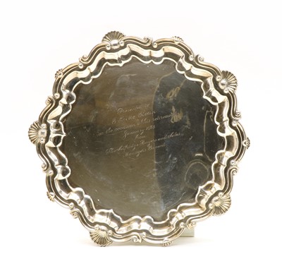 Lot 42 - A silver salver with C scroll shell border