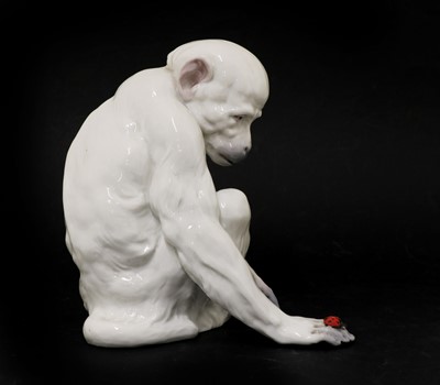 Lot 212 - A porcelain figure of a monkey observing a ladybird