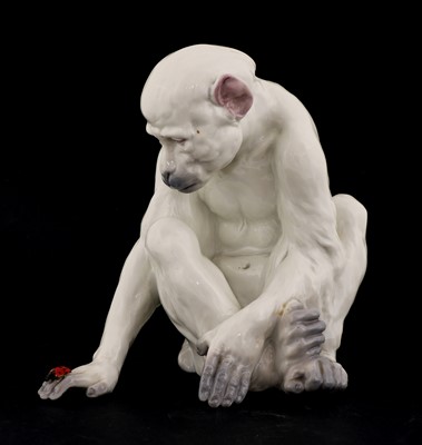 Lot 212 - A porcelain figure of a monkey observing a ladybird