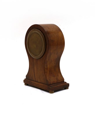 Lot 46 - An Edwardian mantel clock and an oak tray