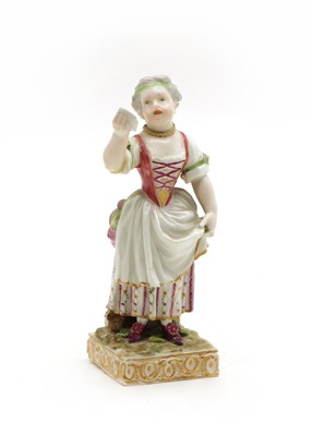 Lot 104 - A porcelain figure of a lady singing