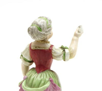Lot 104 - A porcelain figure of a lady singing