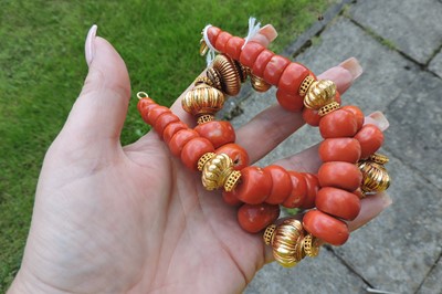 Lot 235 - A single row graduated coral and high carat gold bead necklace