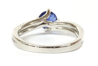Lot 126 - A platinum single stone sapphire crossover ring