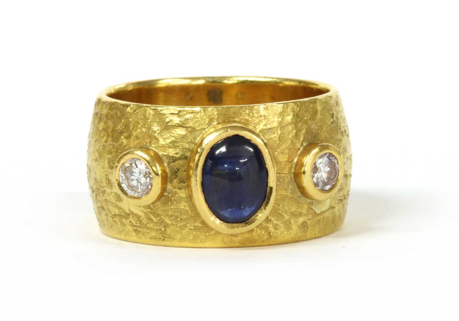 Lot 160 - A gold sapphire and diamond three stone band ring