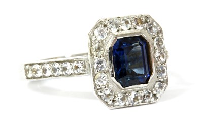 Lot 128 - An 18ct white gold sapphire and white sapphire halo cluster ring