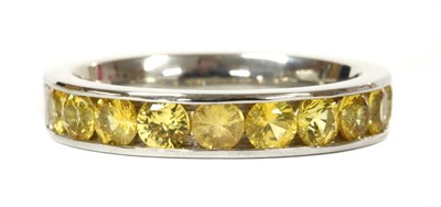 Lot 196 - A platinum yellow sapphire half eternity ring