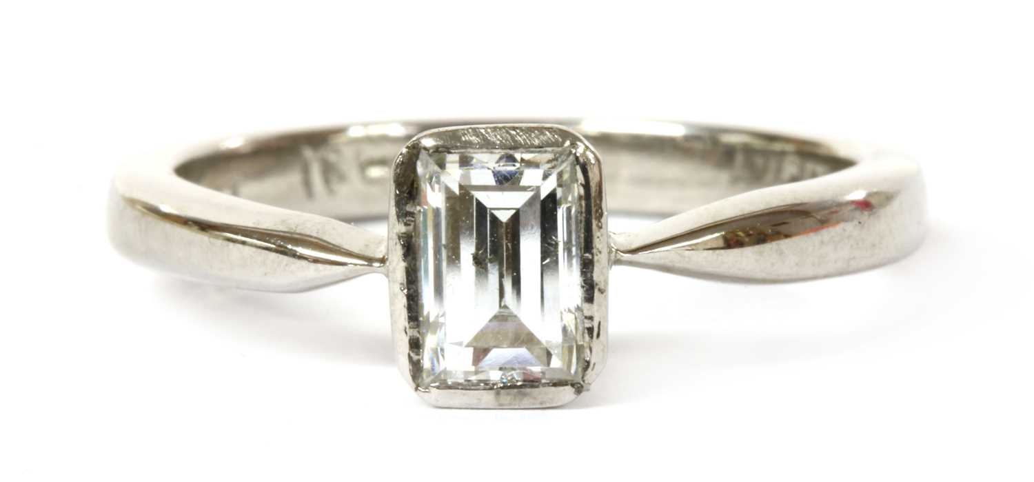 Lot 77 - A white gold single stone emerald cut diamond ring