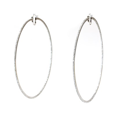 Lot 407 - A pair of large white gold diamond set hoop earrings