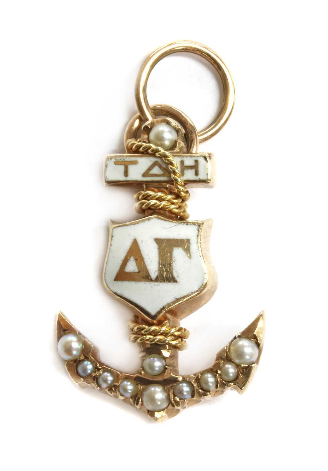Lot 18 - An American gold enamel and split pearl Delta Gamma sorority charm