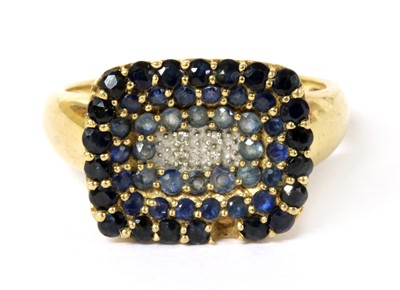 Lot 140 - A 9ct gold diamond and sapphire cluster ring