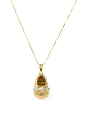 Lot 57 - An 18ct gold diamond set shoe pendant