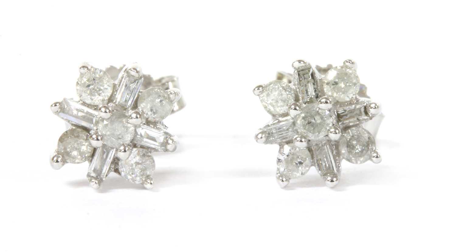 Lot 86 - A pair of white gold diamond cluster earrings