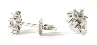Lot 86 - A pair of white gold diamond cluster earrings